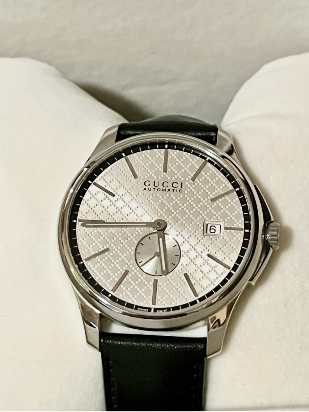 Gucci G-Timeless Automatic watch features a 40mm stainless steel case with a sil